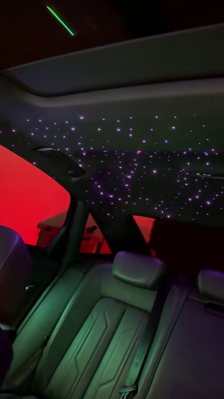 Purple star lights across a car headliner