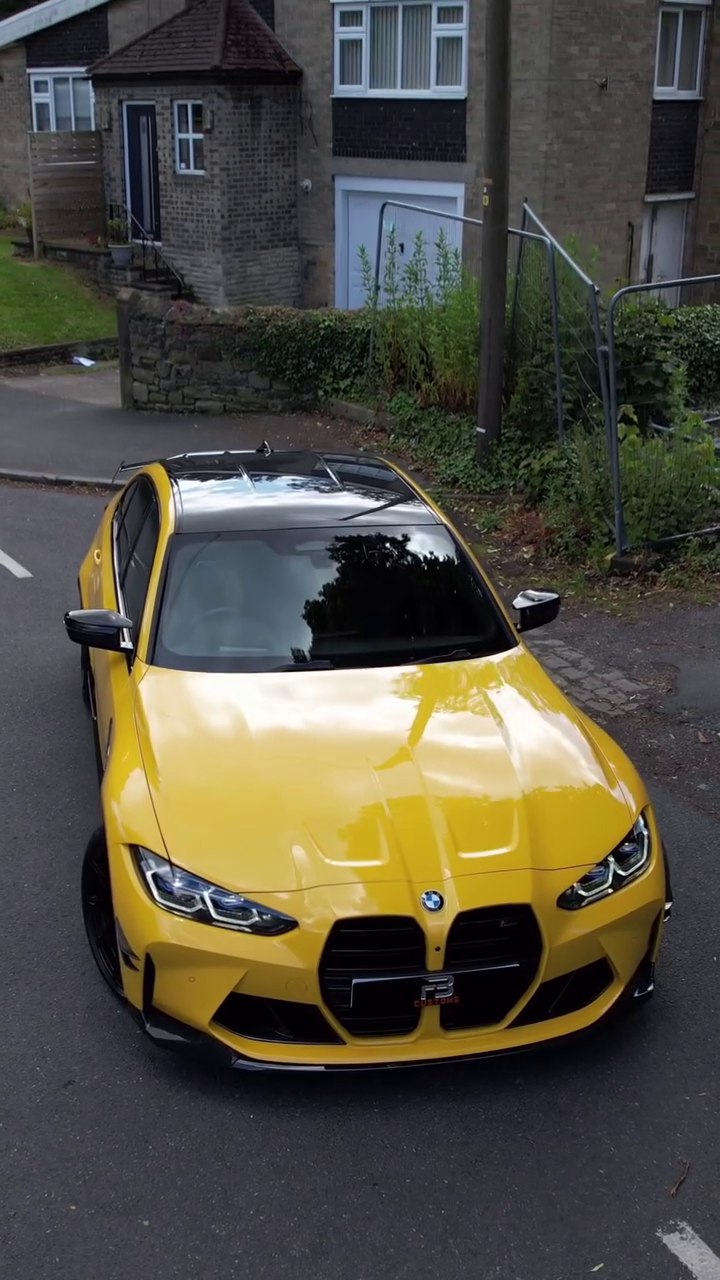 Front view of a yellow BMW M3